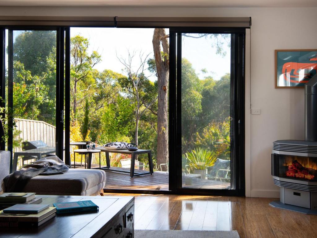 a living room with a large sliding glass door at Retreat 34A in Daylesford