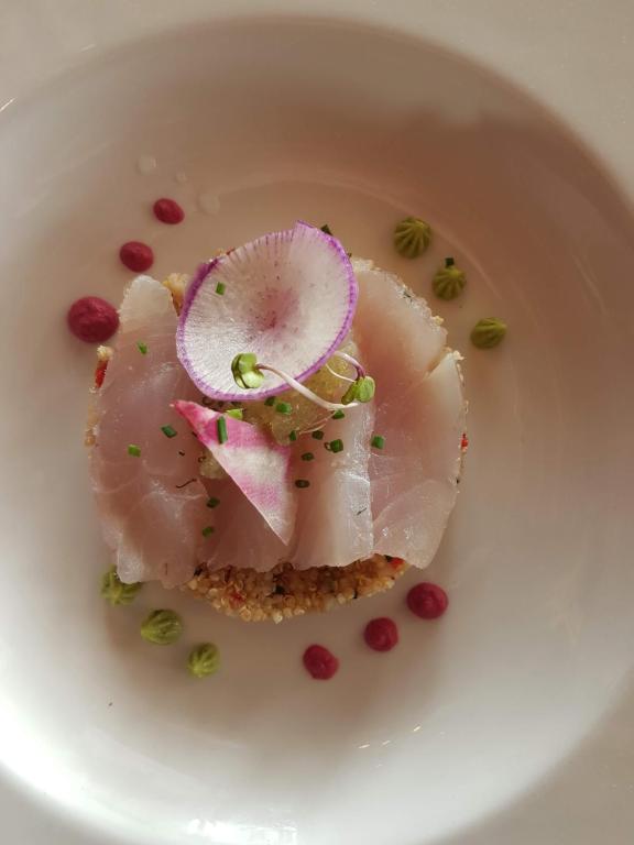 a white plate with a piece of food on it at Hôtel L'Albatros in Saint-Trojan-les-Bains