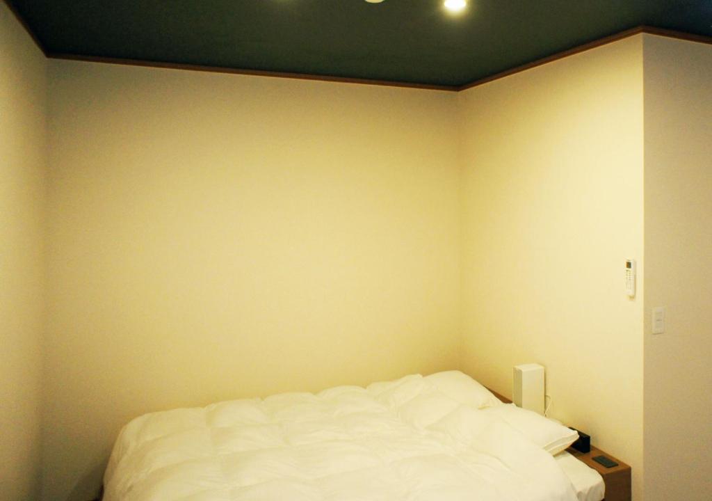 Postel nebo postele na pokoji v ubytování ATAMI SPRING TERRACE HOTEL