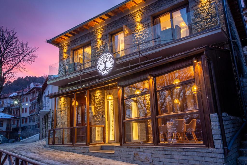 a building with a clock on the side of it at Adryades luxury apartments in Metsovo