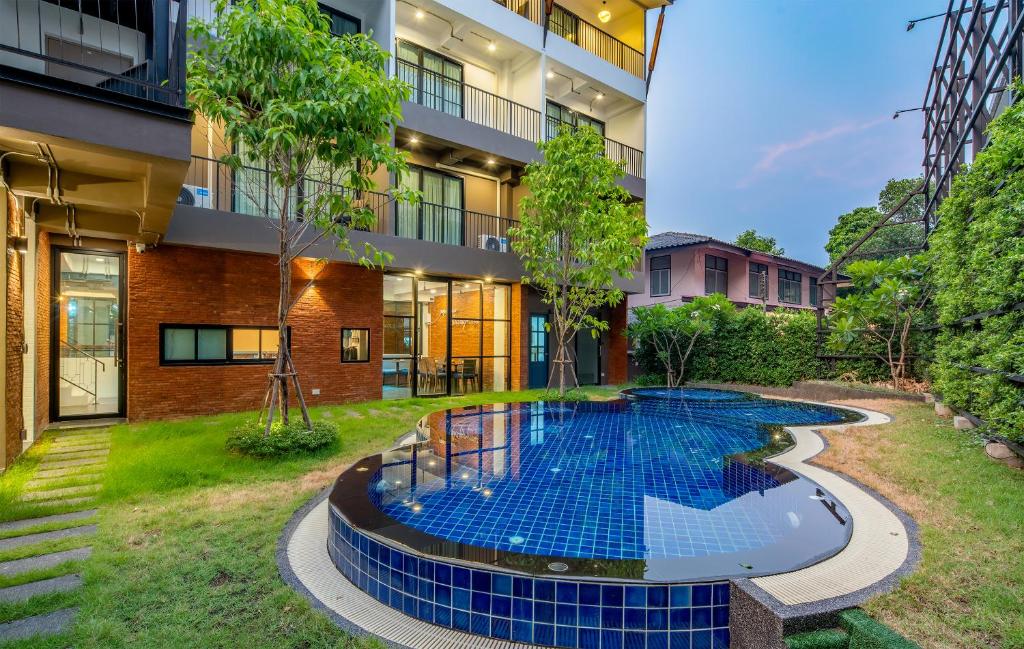a swimming pool in the courtyard of a building at Momo Hotel in Chiang Mai