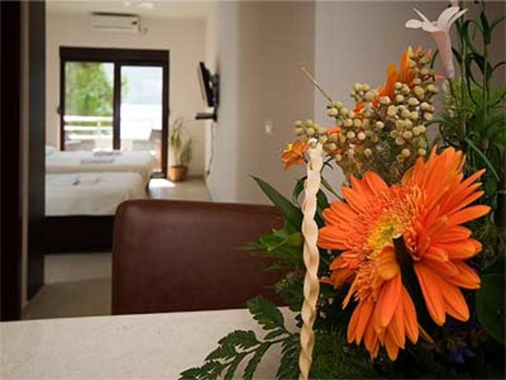 a vase of orange flowers sitting on a table at Apartments Twins in Herceg-Novi