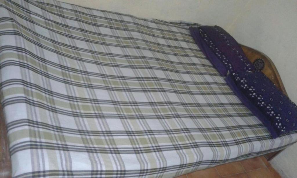 A bed or beds in a room at Xavier Guest House