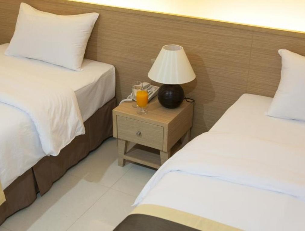 Postel nebo postele na pokoji v ubytování Gateway Hotel Pratunam