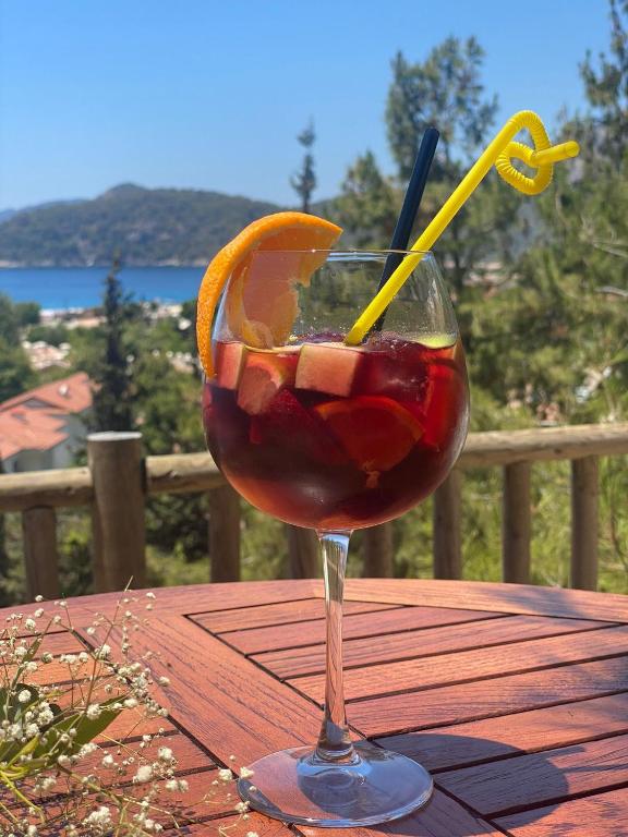 a drink in a glass on a table with an orange slice at Symbola Oludeniz Beach Hotel in Oludeniz