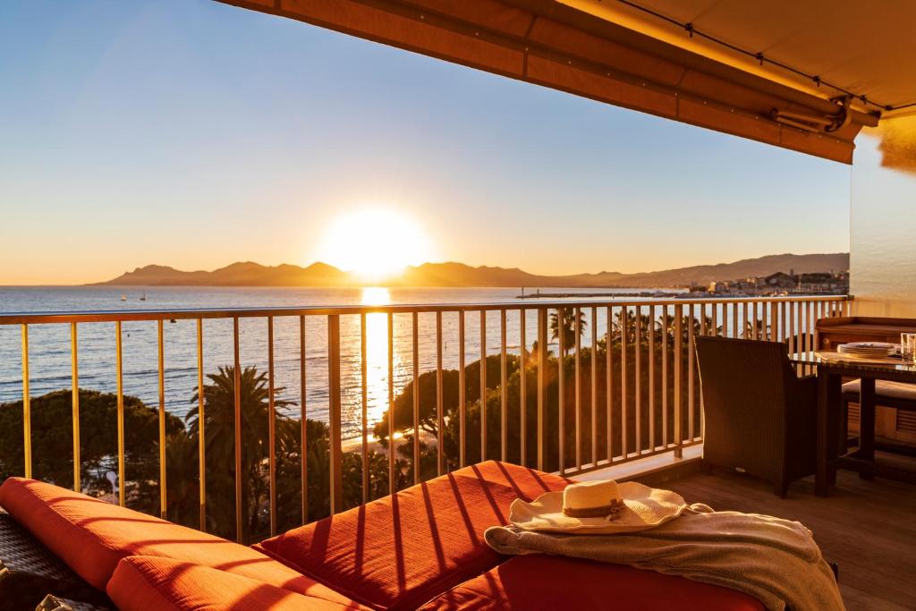 a balcony with a view of the ocean at sunset at Rabelais in Cannes