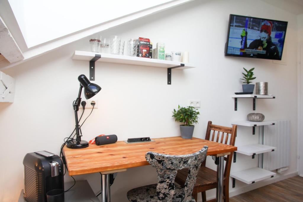 a dining room table with a lamp and two chairs at gemütliches tiny apartment - nur 10min vom Zentrum in Stuttgart