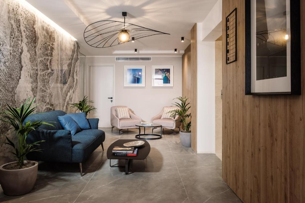 a living room with a blue couch and a table at Amery House in Sliema