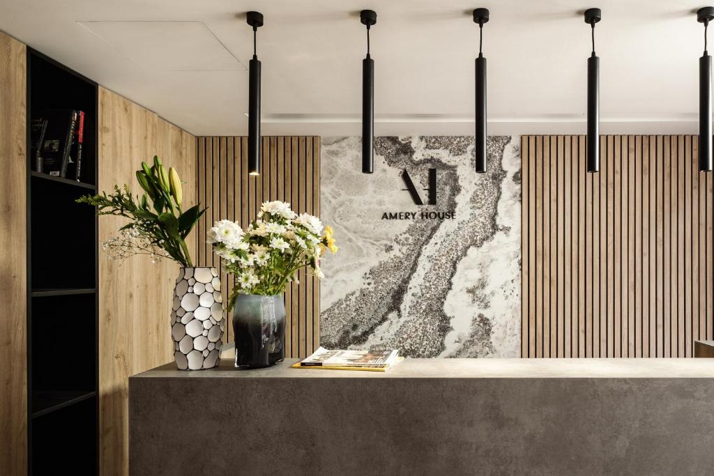 a counter with flowers in a vase on it at Amery House in Sliema