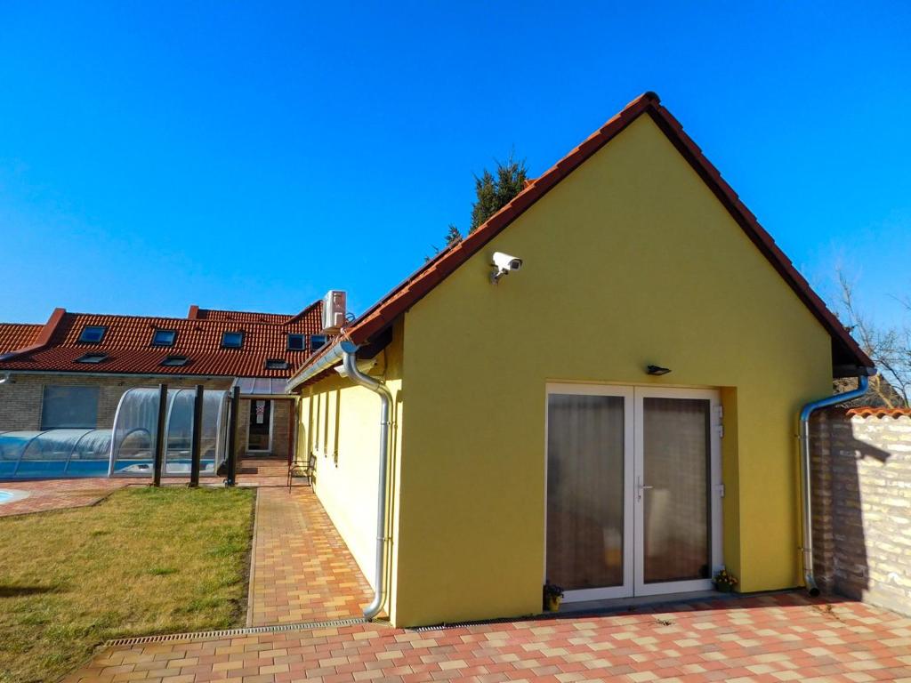 Dávod的住宿－Csónak Vendégház，黄色的房屋,有红色的屋顶