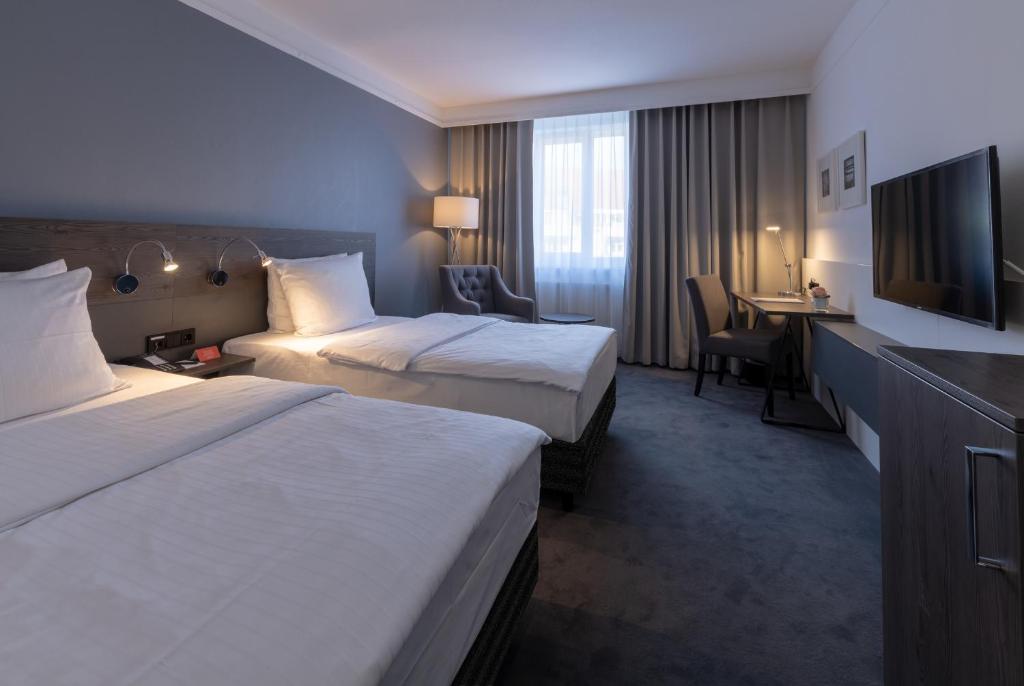 Postel nebo postele na pokoji v ubytování Lindgart Hotel Minden