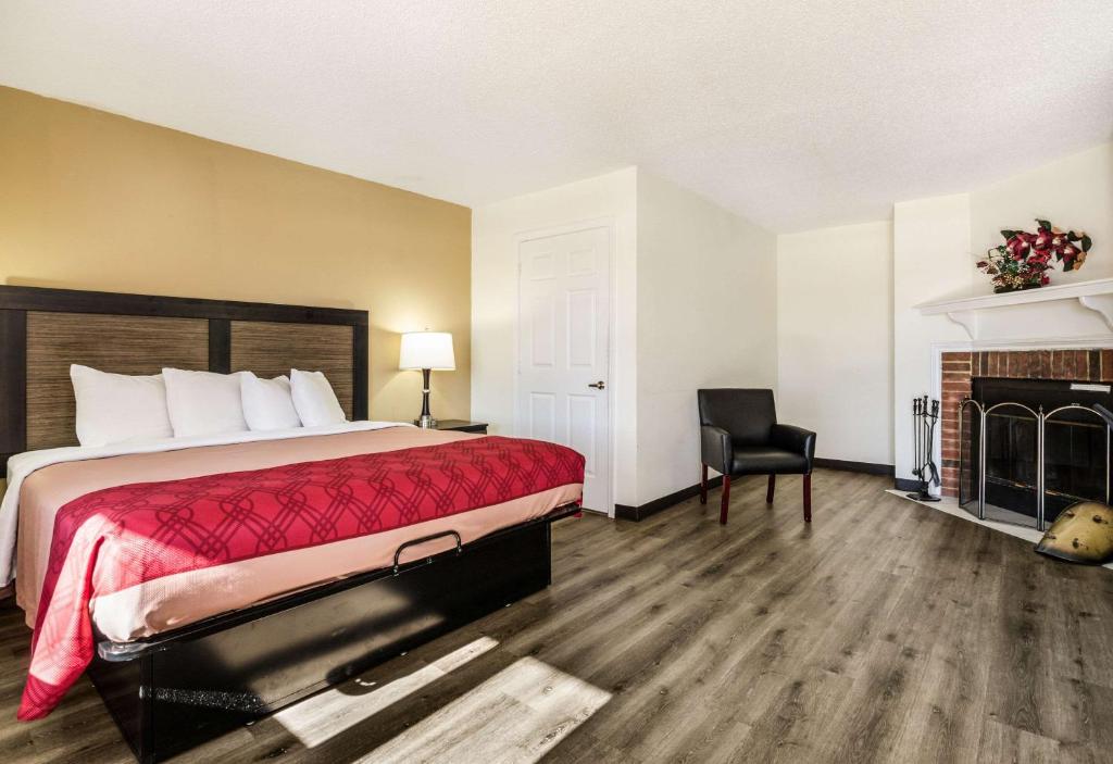 a hotel room with a bed and a fireplace at Econo Lodge Glade Springs I-81 in Glade Spring
