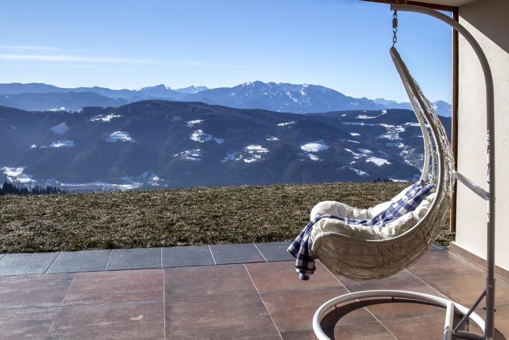 a hammock on a balcony with a view of mountains at Studio 1111 with Sauna & Hot Tub in Dravograd