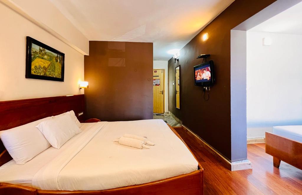 Postel nebo postele na pokoji v ubytování Hotel Jc Grand