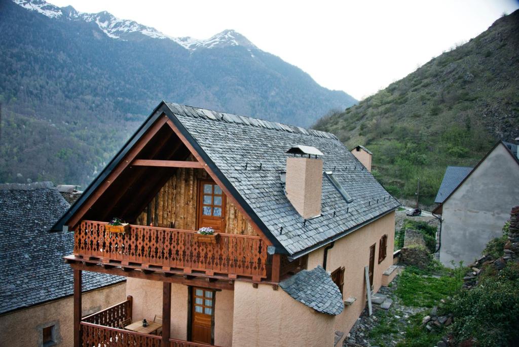 a house with a balcony and mountains in the background at Casa Helipa in Arró