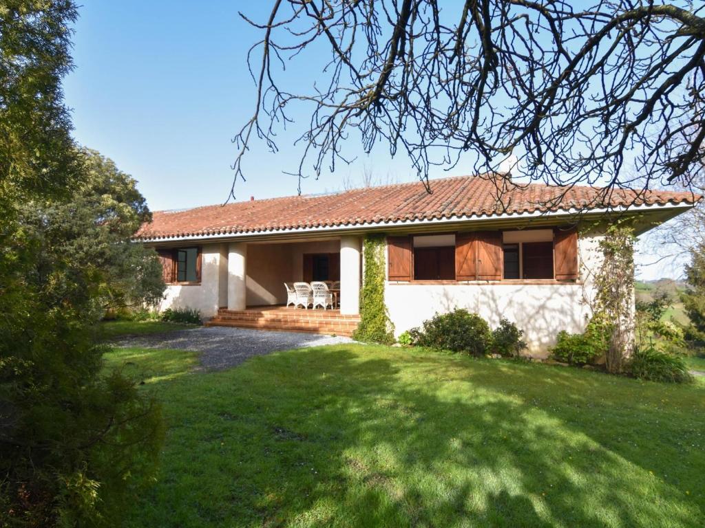 uma casa com um relvado verde em frente em Cómoda y acogedora casa en precioso entorno em San Miguel de Meruelo