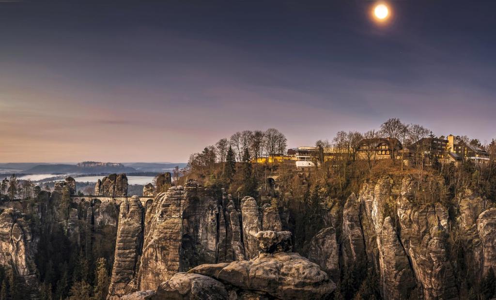 a view of a mountain with the moon in the sky at Berghotel Bastei in Lohmen