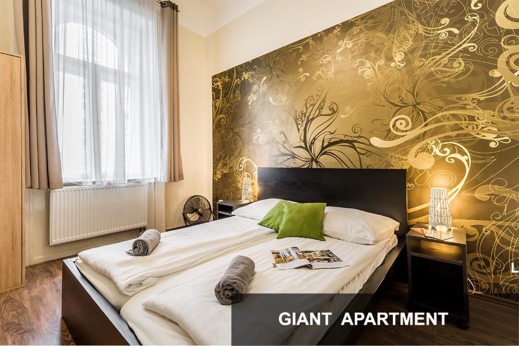 Un dormitorio con una cama grande con una pared de acento verde en BpR Weiner Apartments, en Budapest