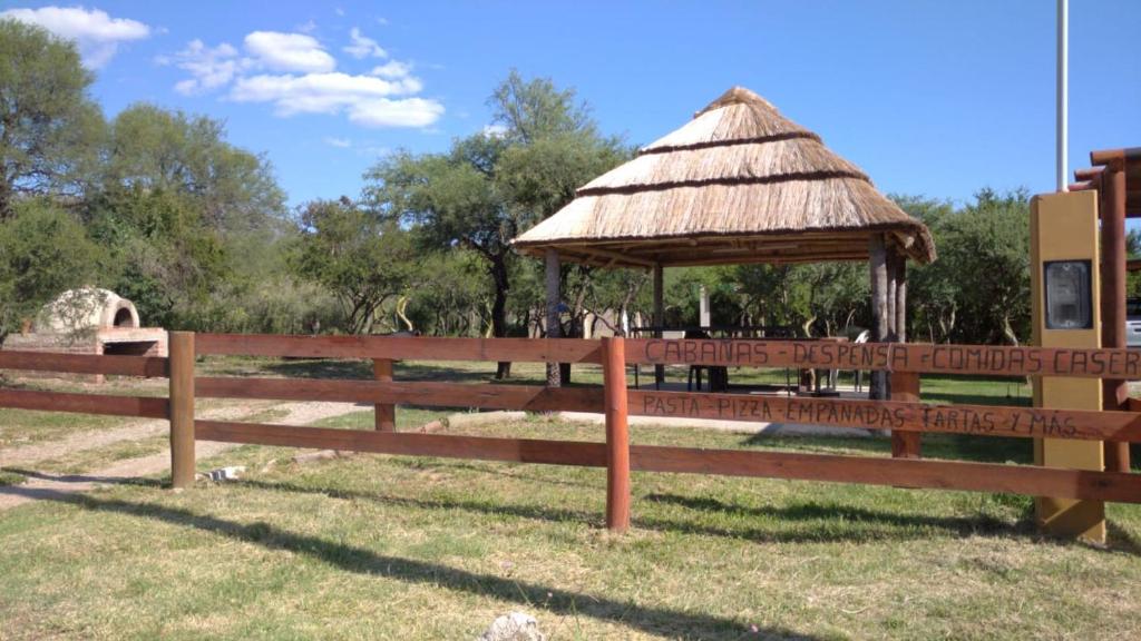 a wooden fence with a gazebo in a field at Bosquecito de Carpin in Carpintería