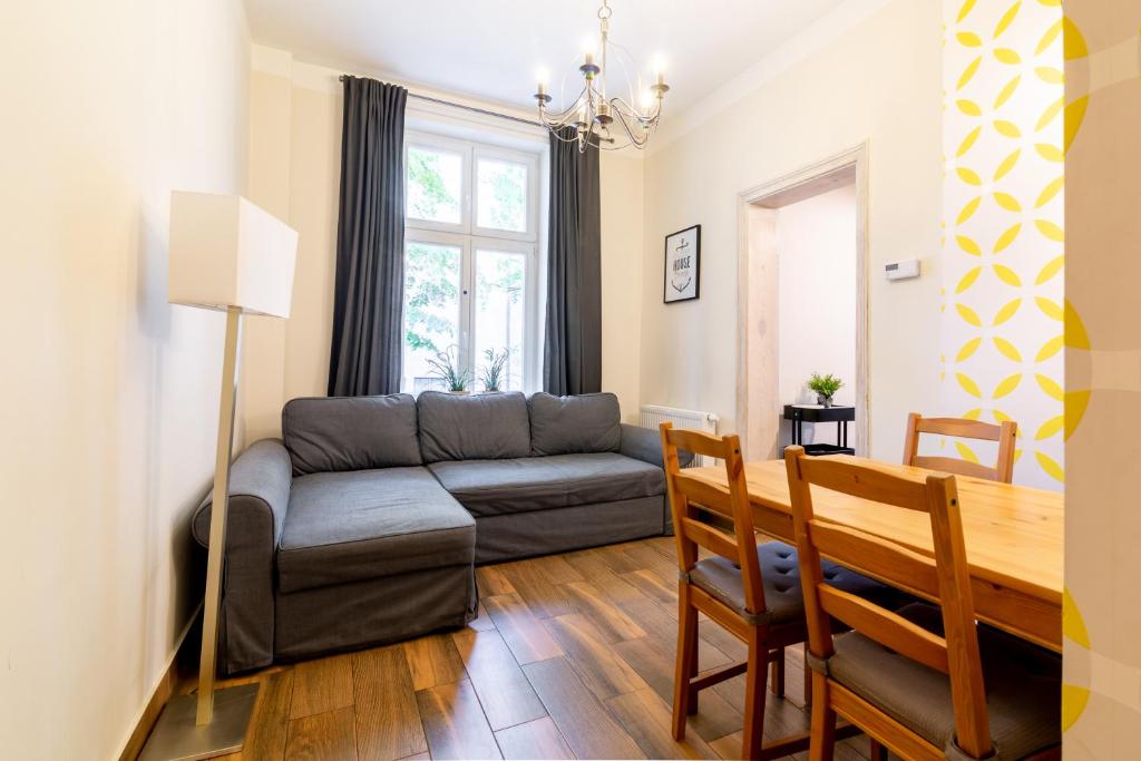 a living room with a couch and a table at Apartamenty Przy Plaży in Sopot