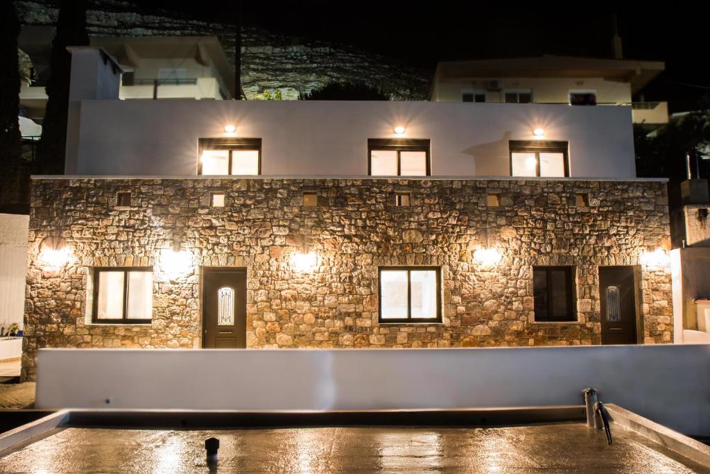 a stone building with lights in front of it at Roccia di Isidoro in Áyios Isídhoros