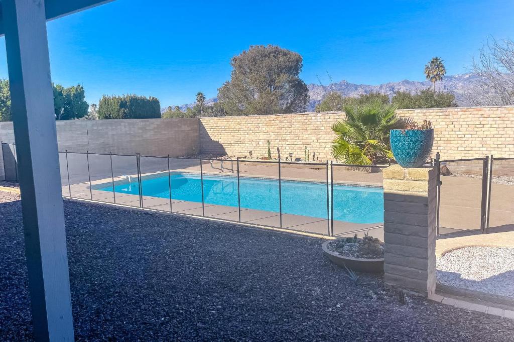 a swimming pool with a fence around it at Manassas Place in Tucson