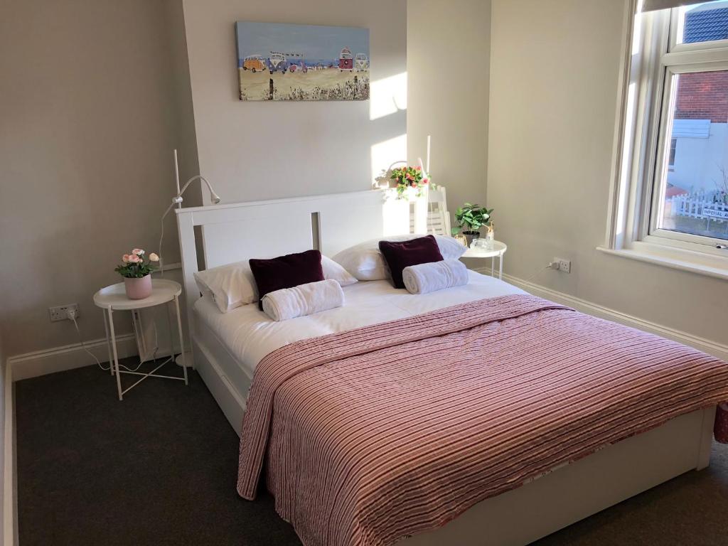 a bedroom with a bed with two pillows on it at Three Bedroom City Home with Garden in Southampton