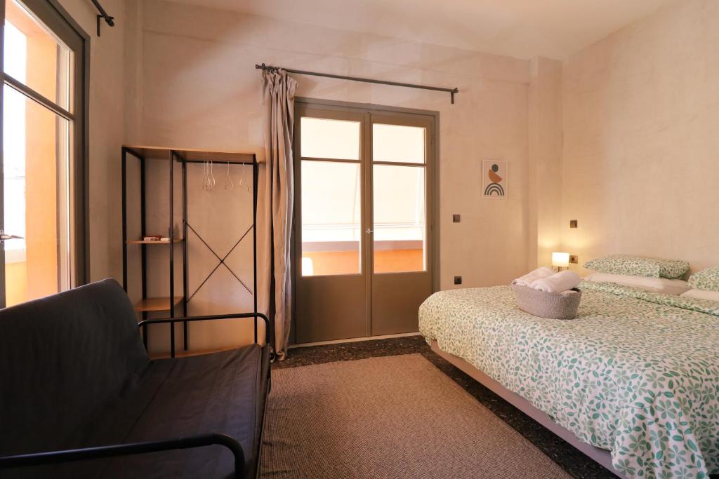 1 dormitorio con 2 camas y puerta corredera de cristal en Staying in Athens, en Atenas