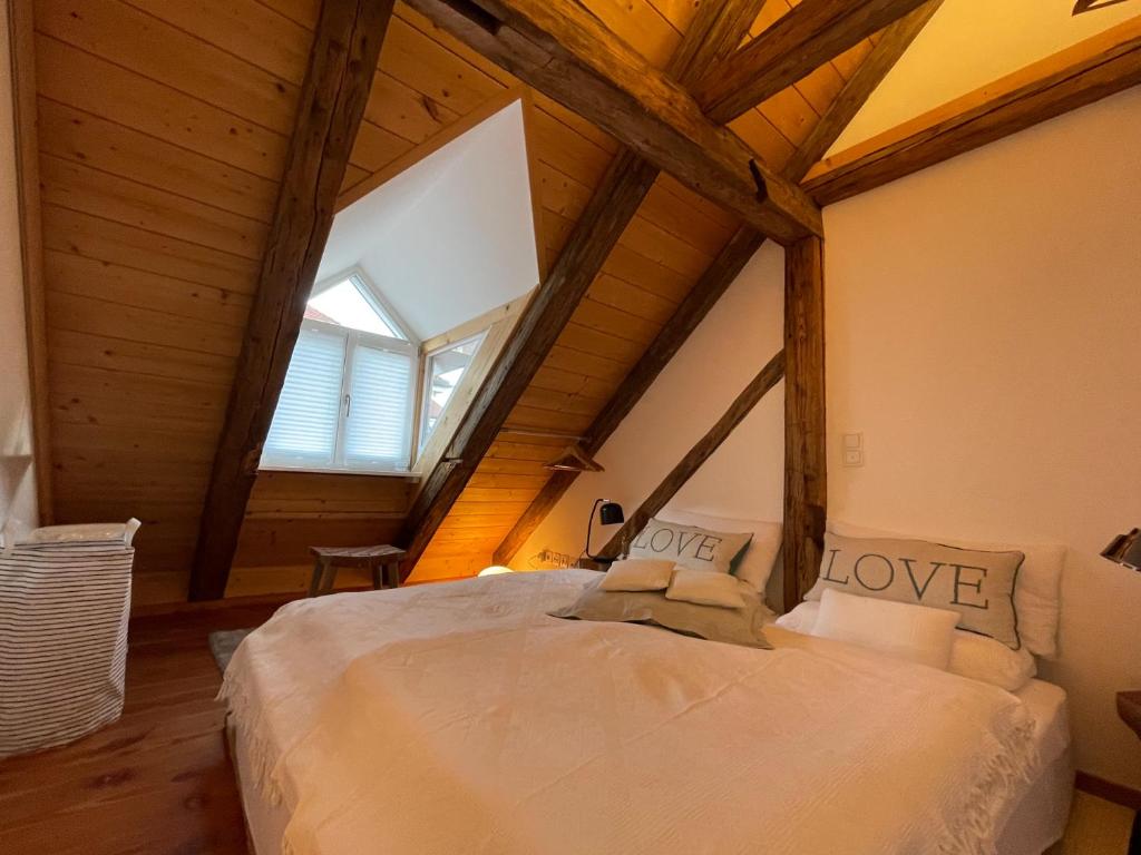 a bedroom with a large bed in a attic at INVERA HOME in Murnau am Staffelsee