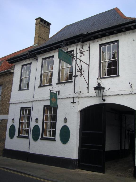 a white building with a large doorway in front of it at Crown Hotel in Downham Market