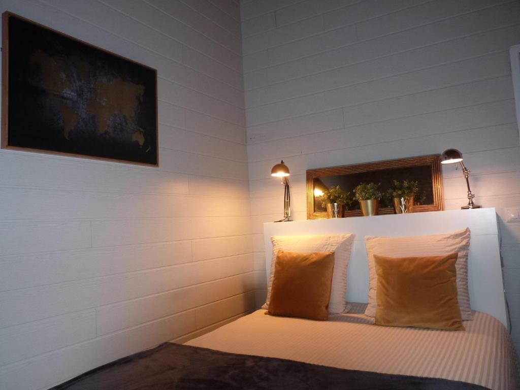 a room with a bed with two pillows at "la suite" in Talant