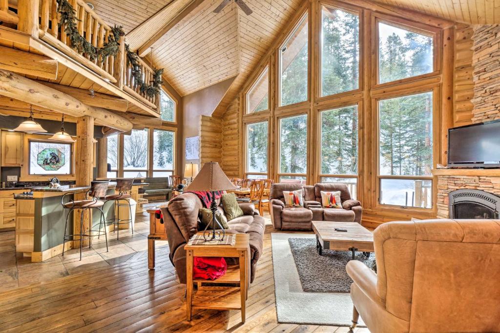 a living room filled with furniture and a fireplace at Rustic Cabin with Hot Tub and Deck in Breckenridge in Breckenridge
