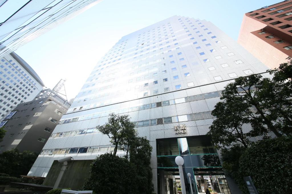 a tall white building in a city at Shinjuku Washington Hotel Annex in Tokyo