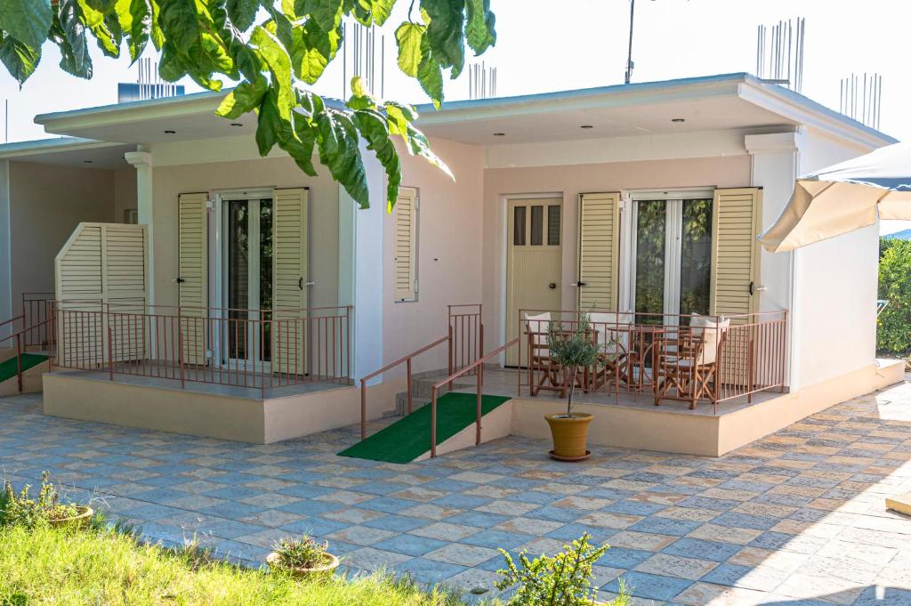 a house with a porch and a patio at Anesis Residence in Drepana