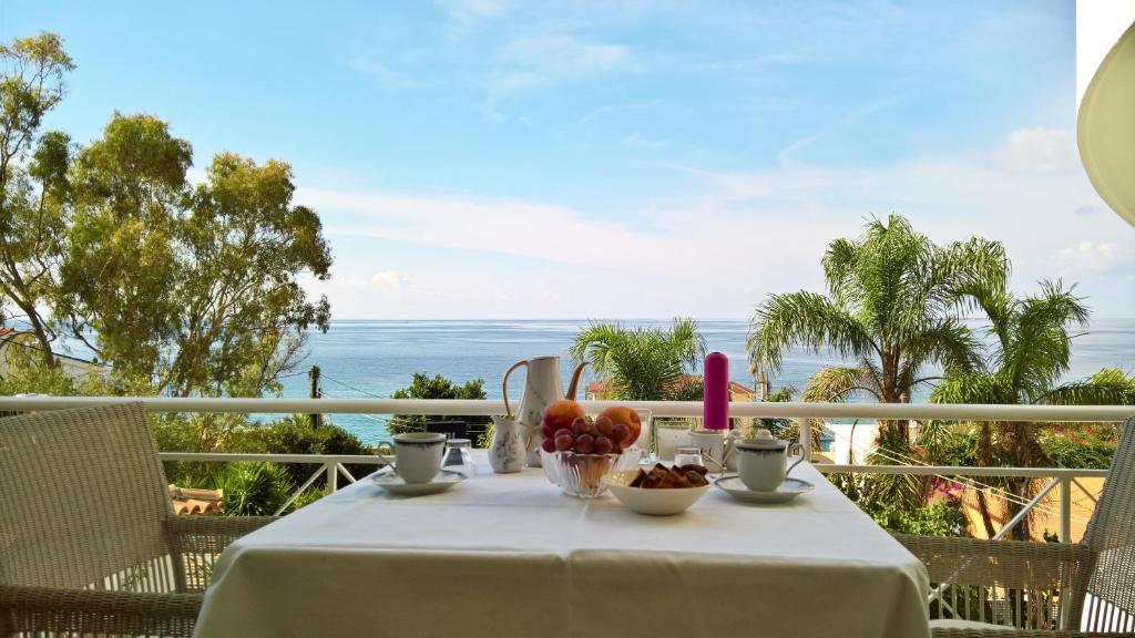 a table on a balcony with a view of the ocean at Stavento Apartments in Argostoli