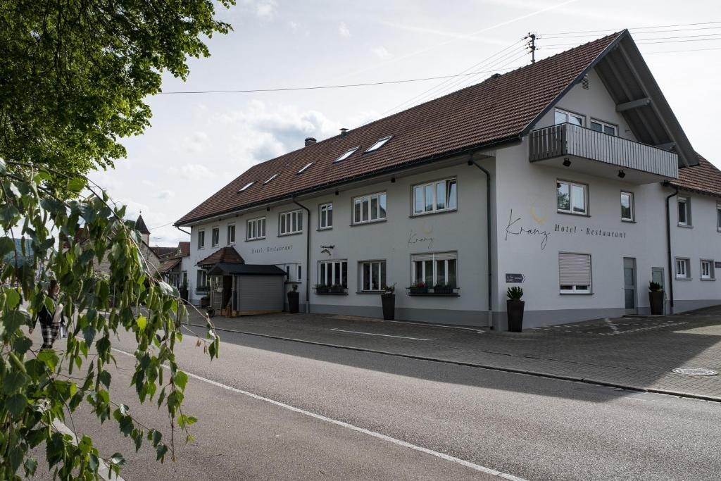 a white building on the side of a street at Gasthaus Hotel Kranz in Laufenburg