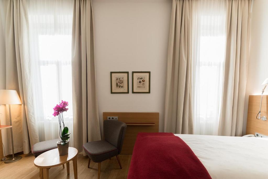 Łóżko lub łóżka w pokoju w obiekcie Hotel Stiegl Scala