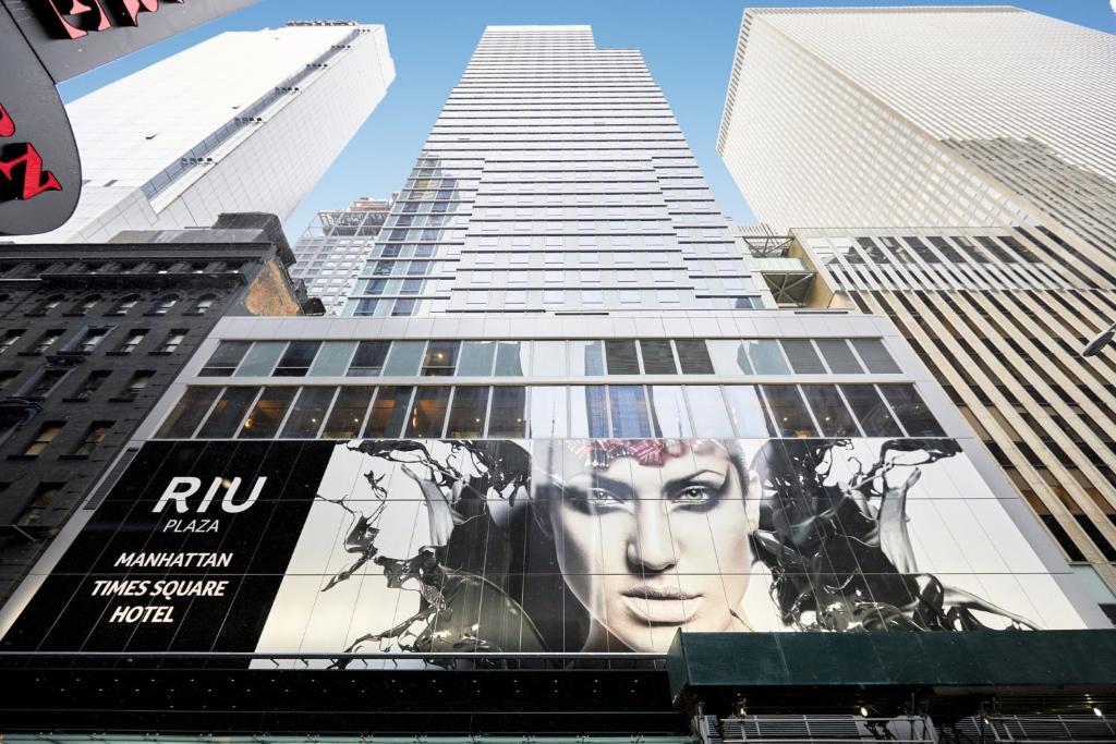 a building with a poster on the side of it at Riu Plaza Manhattan Times Square in New York