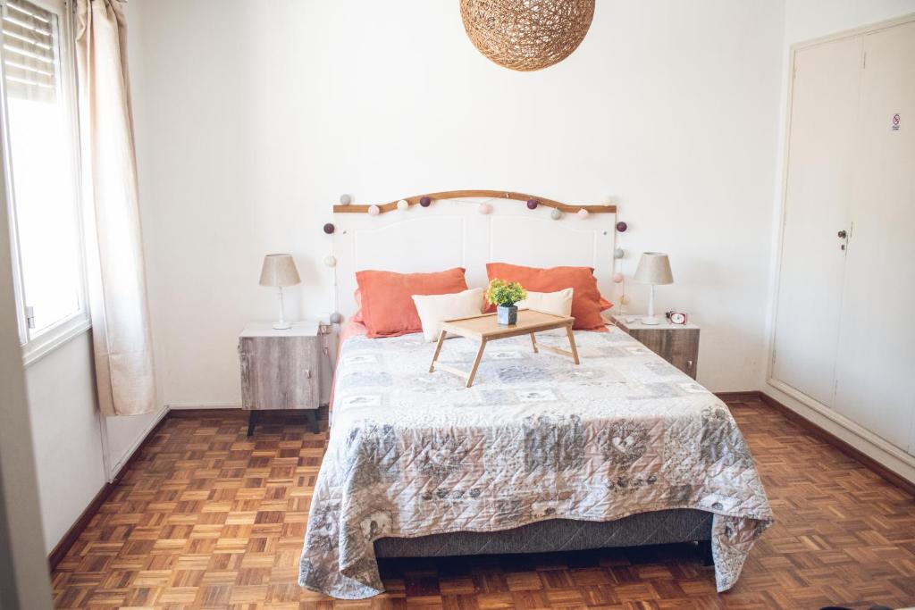 a bedroom with a large bed with a table on it at Apto. entero Ciudad Vieja in Montevideo