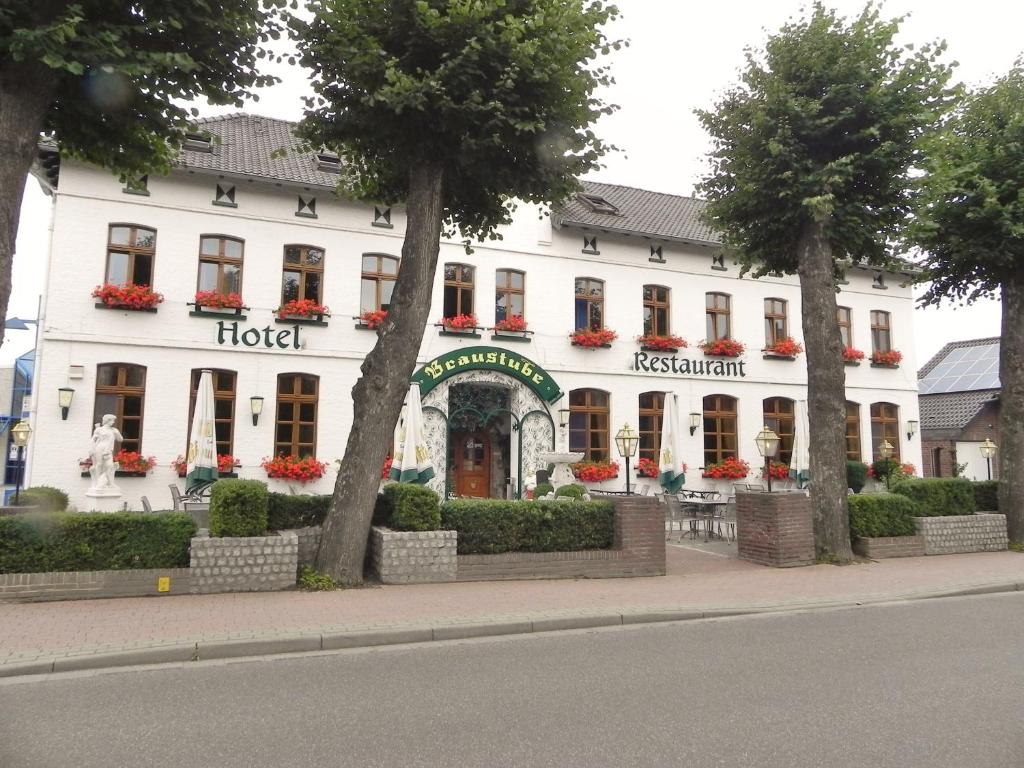 a hotel on the side of a street with trees at Hotel - Restaurant Braustube in Haaren