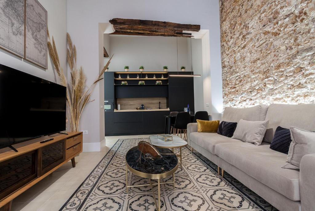 a living room with a couch and a tv at Casa Mariana - Luxury Apartment - 4 Personas in Cádiz