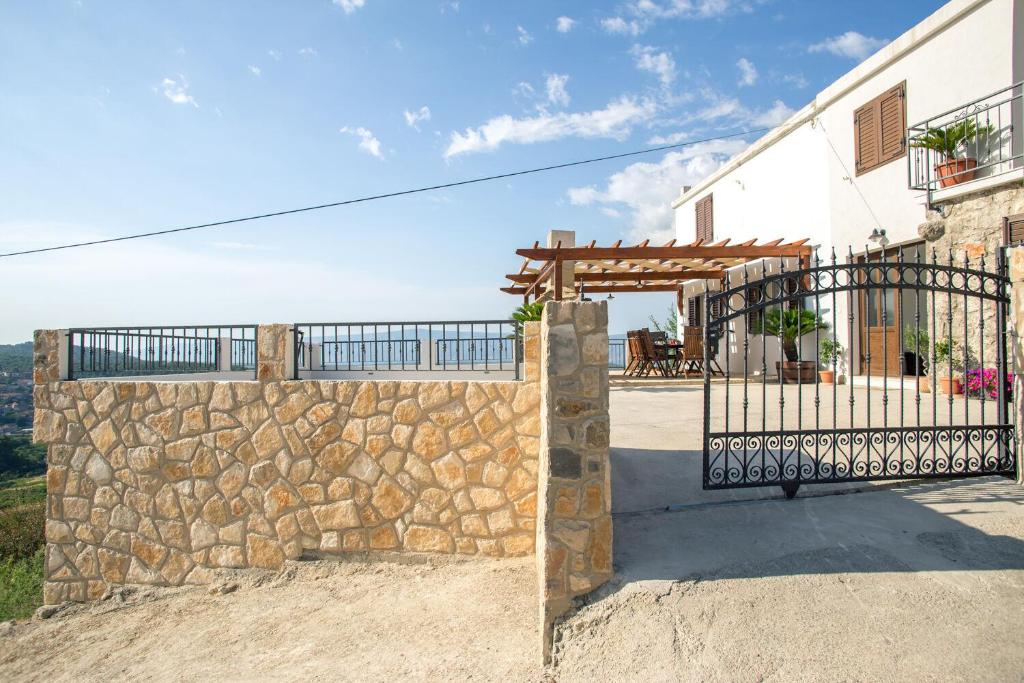 a gate to a house with a stone wall at Apartment Peace and quiet in Jelsa