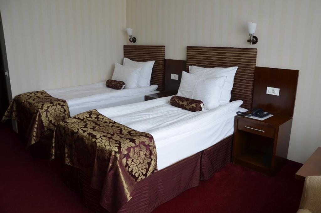Postel nebo postele na pokoji v ubytování Grand Hotel Napoca