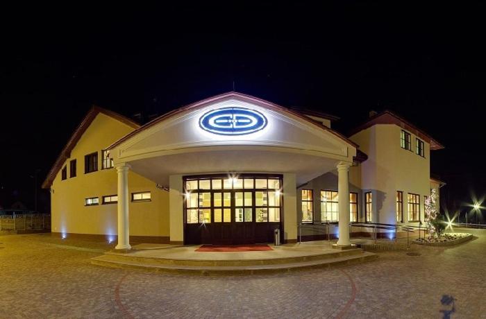 a bmw dealership with a sign on the front at Hotel Dudek in Mniów