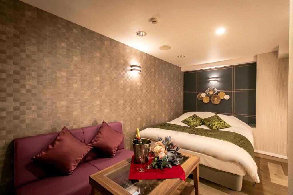 Postel nebo postele na pokoji v ubytování Hotel EXE アネックス 大人専用