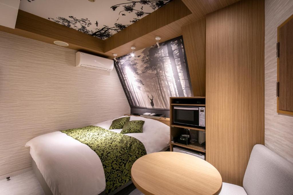 Postel nebo postele na pokoji v ubytování Hotel EXE アネックス 大人専用