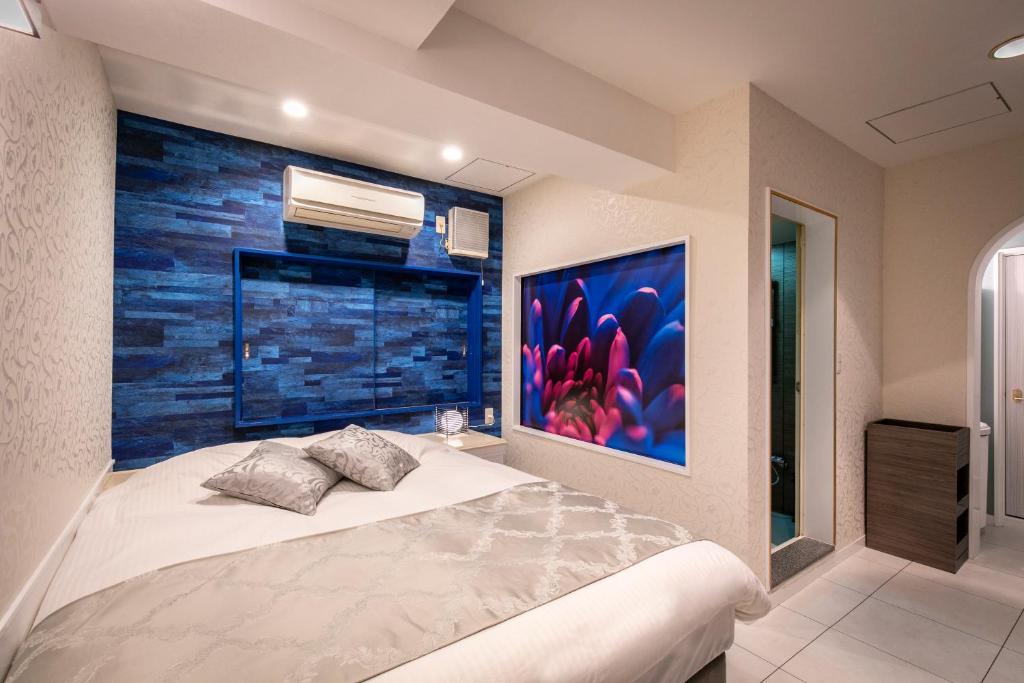 Postel nebo postele na pokoji v ubytování Hotel EXE アネックス 大人専用