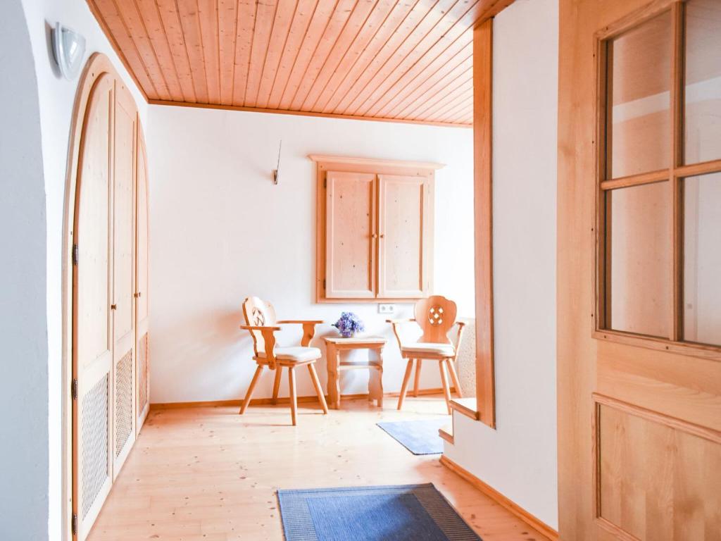 a hallway with a table and chairs and a door at Scenic Apartment in Rattenberg near Reintaler See Lake in Rattenberg