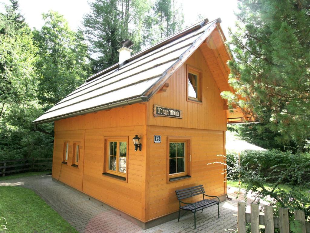 a small wooden house with a bench in a yard at Holiday home in Bad Kleinkirchheim near ski area in Bad Kleinkirchheim