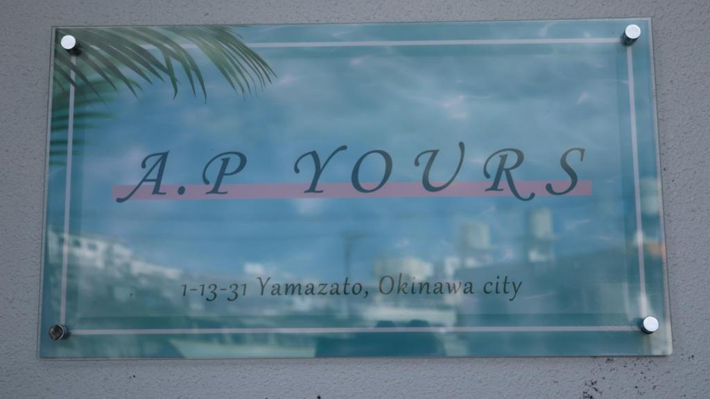a sign that says ap yews on a window at AP Yours 401 in Okinawa City